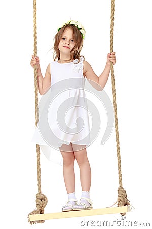 Little girl swinging on a swing Stock Photo