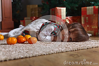 Little girl with tangerines Stock Photo