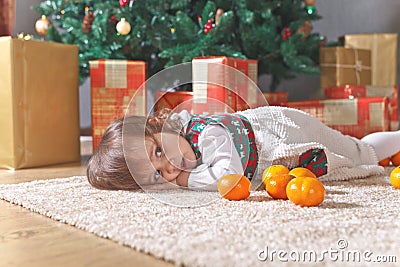 Little girl with tangerines Stock Photo