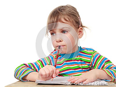 Little girl thinks, pencil in hand Stock Photo