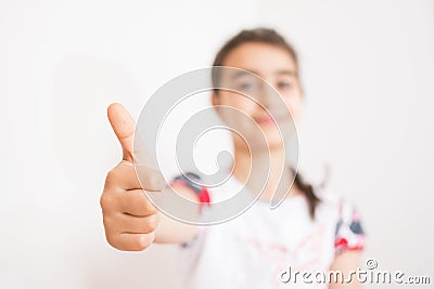 Little girl with thumb raised in sign of approval Stock Photo