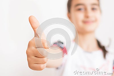 Little girl with thumb raised in sign of approval Stock Photo