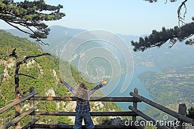 Little girl with thumbs up enjoy in nature viewpoint Banjska stena Tara Stock Photo