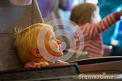 Little girl tired and bored in plane, child afraid of flying Stock Photo