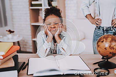 Little Girl Tired. and Think. Mom Help Young Girl. Stock Photo