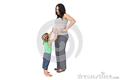 Little girl touching her mothers baby bump Stock Photo