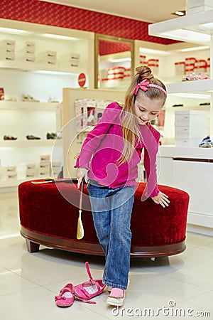 Little girl tries on new shoe Stock Photo