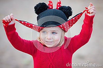 Little girl two years old having fun playing peek a boo with her hat. Portrait. Stock Photo