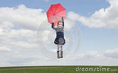 Little girl with umbrella flying in the air Stock Photo
