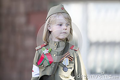 Little girl in uniform of a second world war soldier. Editorial Stock Photo