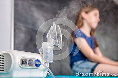 Little girl waiting for medical inhalation treatment with a nebulizer Stock Photo