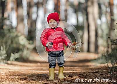 Little girl walking in the forest Stock Photo
