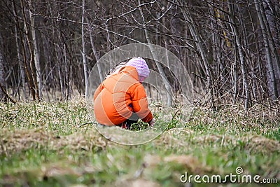 Little girl walks outdoors. Happy child in countryside. Early spring. Stock Photo