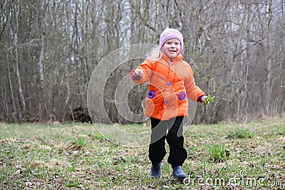 Little girl walks outdoors. Happy child in countryside. Early spring. Stock Photo