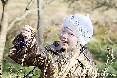 Little girl walks outdoors. Happy child in countryside. Early spring. Stock Photo