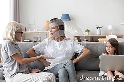 Small girl witness mother and grandmother arguing at home Stock Photo