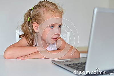 Little girl watching cartoons. Stock Photo