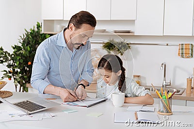 Little girl watching her father measuring distance Stock Photo