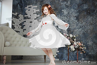 Little girl in white dress are dansing Stock Photo