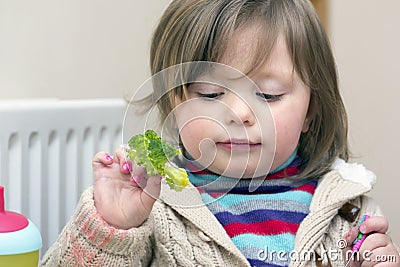 Little girl whose face and sweater is smudged with paint Stock Photo