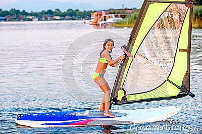 Little girl winsurfing on Ada Bojana, Montenegro Stock Photo