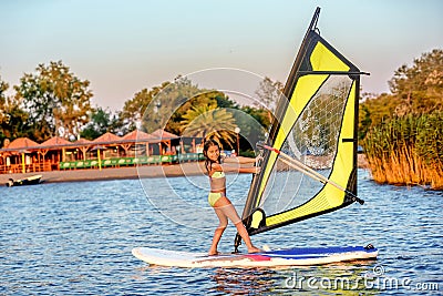 Little girl winsurfing on Ada Bojana, Montenegro Stock Photo