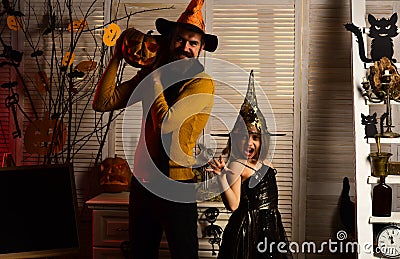 Little girl in wiz hat with creepy hands. Little girl and father do wiz magic. Happy family celebrate halloween. Happy Stock Photo