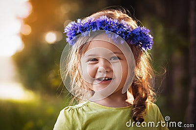 Little girl in a wreath of cornflowers Stock Photo