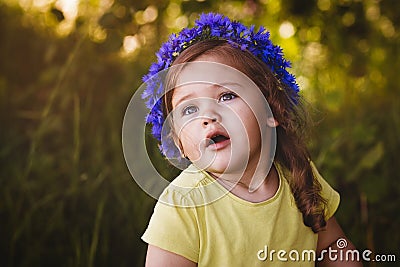 Little girl in a wreath of cornflowers Stock Photo