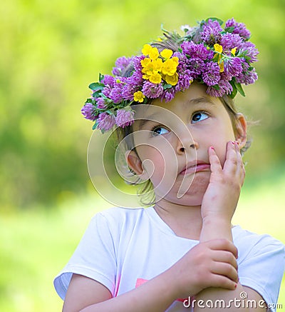 Little girl with a wreath of flowers on her head Stock Photo