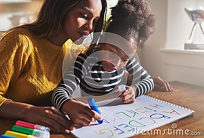 Little girl writing the alphabet Stock Photo