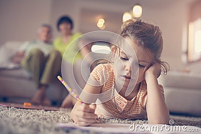 Little girl writing at home. Stock Photo