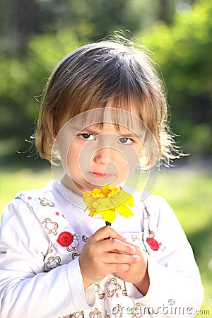 Little girl with yellow flower Stock Photo