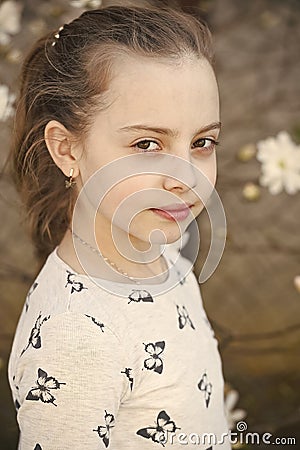 Little girl with young skin on spring or summer day. Child with cute face outdoor. Beauty kid with fresh look and long Stock Photo