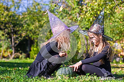 Little girls casting a spell on Halloween in witch Stock Photo