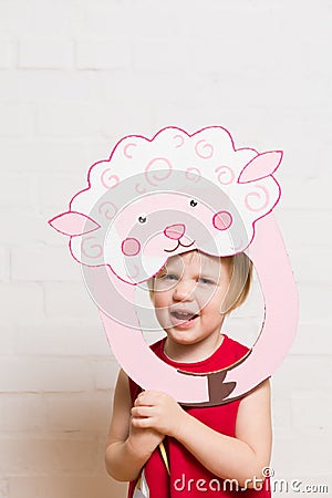 Little girls holding sheep mask on white background Stock Photo