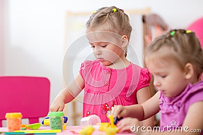 Little girls learning to work colorful play dough Stock Photo