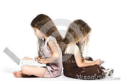 Little girls playing game console back to back Stock Photo