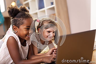 Little girls watching cartoons on laptop computer Stock Photo