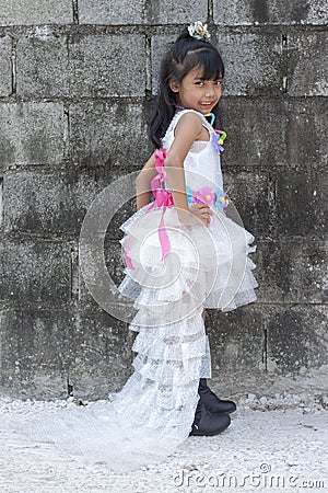 Girls wear dresses made from recycled materials. In order to take advantage of used items. Stock Photo