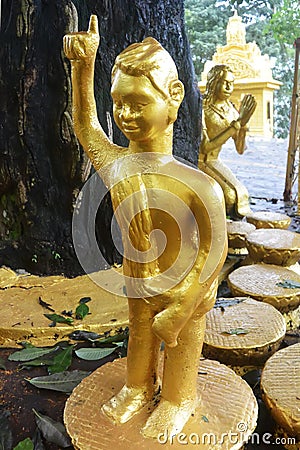 Little golden boy Buddha utters the first truth Stock Photo
