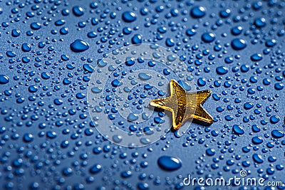 A little golden star and blue water dorops Stock Photo