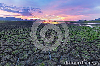 Little grass over crack land and beautiful sky Stock Photo
