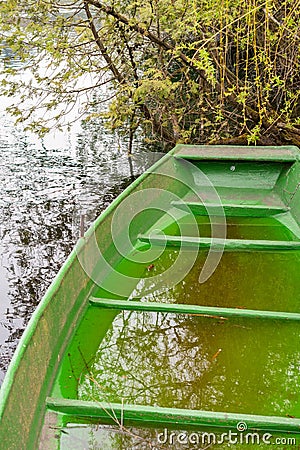 Little green boat in a lake in Werdenberg in Switzerland Stock Photo