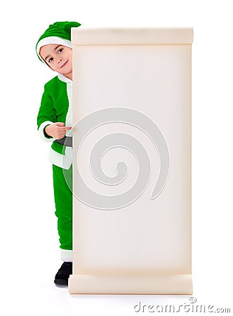 Little green Santa Claus boy pointing at big wish list Stock Photo