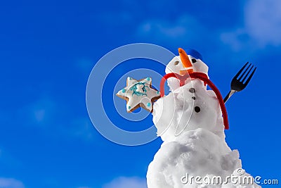 Little happy christmas snowman with cookie star outdoor. Winter season. Stock Photo