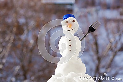 Little happy christmas snowman with fork outdoor. Winter season. Stock Photo