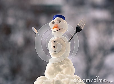 Little happy christmas snowman with fork outdoor. Winter season. Stock Photo