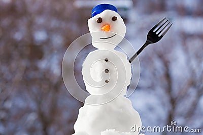 Little happy christmas snowman with fork outdoor. Winter season. Stock Photo