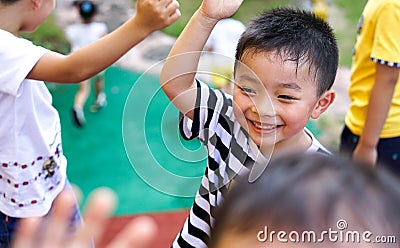 Qingyuan, China - June 23, 2016: Little happy Chinese boy outdoors with his friends Editorial Stock Photo